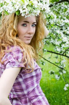 Redheaded woman in cherry tree blossom