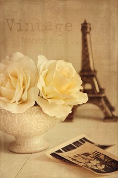 Antique roses with old photos on table