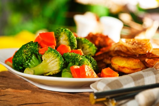 Fried potatoes broccoli carrots and roasted chicken