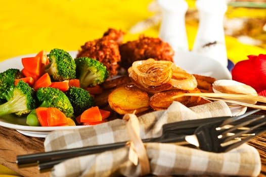 Fried potatoes broccoli carrots and roasted chicken