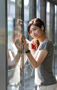 Asian woman listening music in station