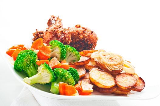 Fried potatoes broccoli carrots and roasted chicken