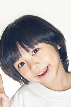 A young asian girl smiling, studio shot.