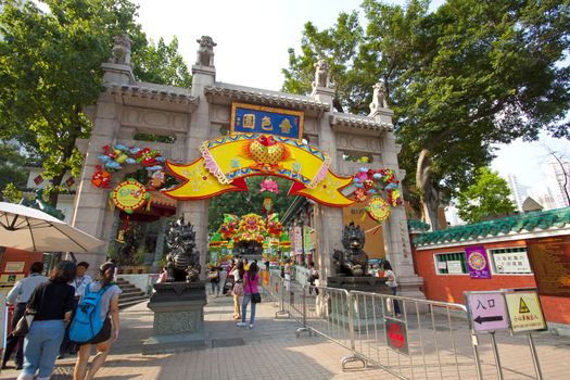 HONG KONG - SEPT 7, Wong Tai Sin Temple with many tourists on 7 September, 2011. There are many people go to worship the god and make a wish every day. It is the main entrance.