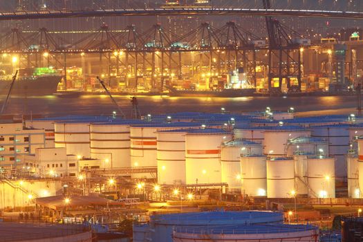 Oil tanks at night in container terminal 
