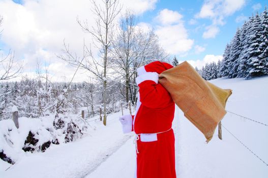 Santa Claus, Father Christmas in a beautiful winter landscape