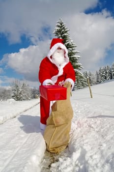 Santa Claus, Father Christmas holds red present