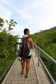 Asian man hiking on hiking trail 