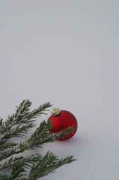 a red bauble in snowy winter landscape