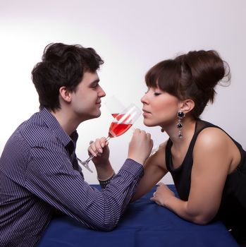 photo of young couple drinking rose wine