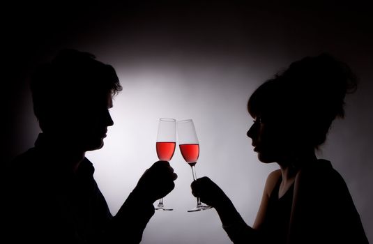 photo of young couple drinking rose wine