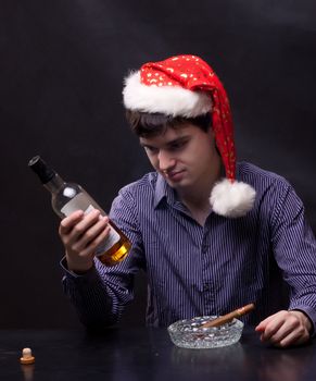 photo of man drinks alcohol and smokes a cigar