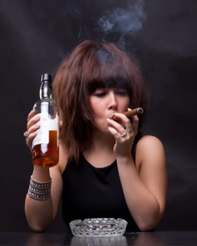 photo of woman drinks alcohol and smokes a cigar