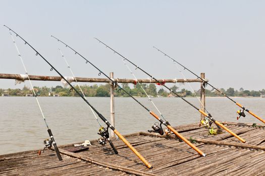 Fishing Poles on Pier with river in Background