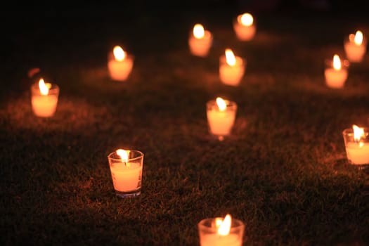 Candles in the grass at a park