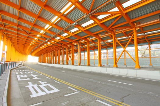 Orange tunnel and highway at day