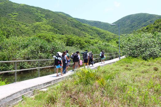 Asian hiking team in mountains of Hong Kong