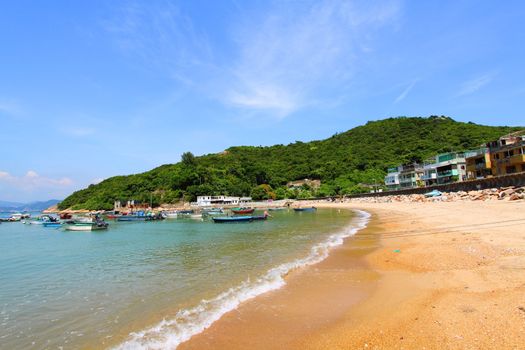 Beach in Hong Kong with many boats and houses