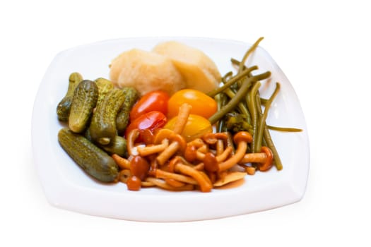 Pickled vegetables on the plate isolated on white background