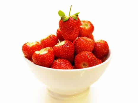 Strawberry fruit in a white bowl, isolated towards white