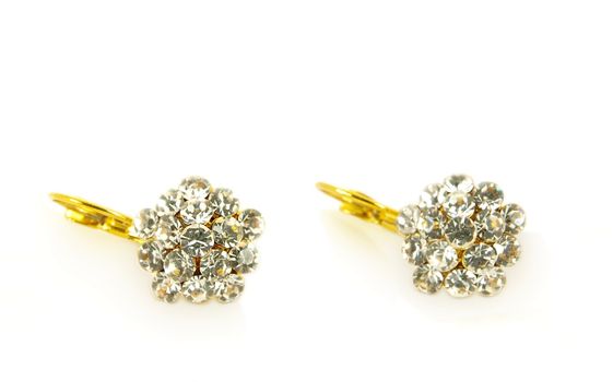 Diamond earrings on yellow gold, isolated towards white background