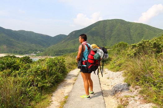 Asian man hiking at summer time