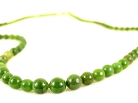 Green gemstone necklace, isolated towards white background