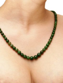 Green gemstone necklace, isolated on female person neck