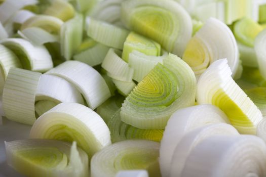 Group of fresh sliced leeks filling frame.
