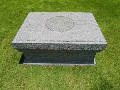 Stone table on grassland front of Dharmacakra in Buddhamonthon, Nakhon Pathom, Thailand