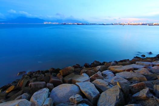 Sunset along the coast in Hong Kong with rocks