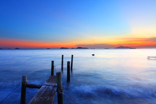 Sunset along a wooden pier in Hong Kong