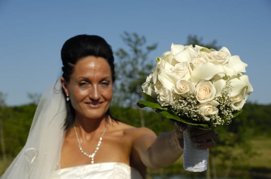 Bride in white dress with flower bouquet