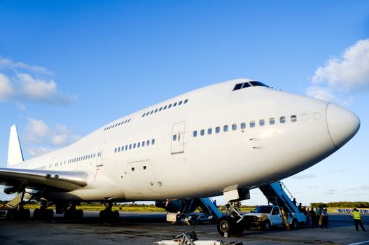 Air travel - A parked plane is loading off Passengers in an airport