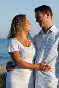 A happy woman and man in love at beach.