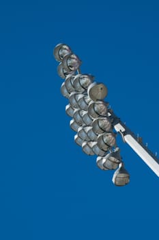 An array of lamps on a stadium lighting support