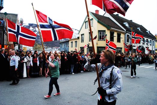 Children carrying the norwegian flag during national day celebration 17th of may 2011.