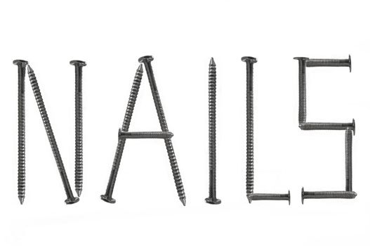 Close up of several steel nails arranged over white to form the word NAILS