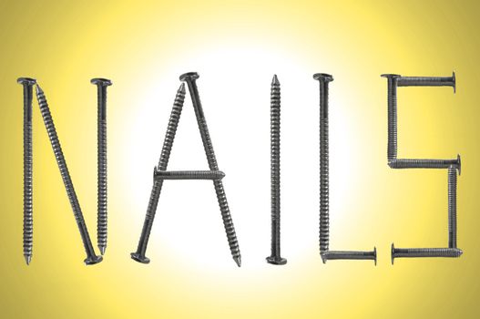 Close up of several steel nails arranged over yellow light effect to spell the word NAILS