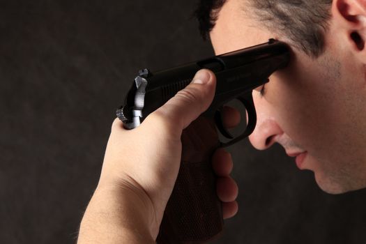 The man with a pistol on a dark background