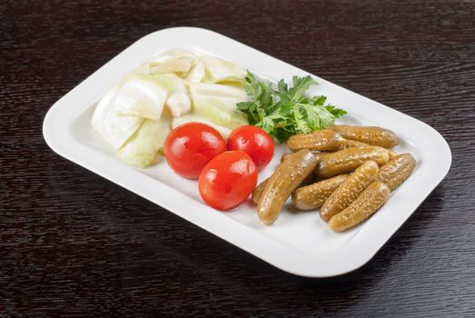 pickled vegetables of tomato, cucumber, cabbage at table