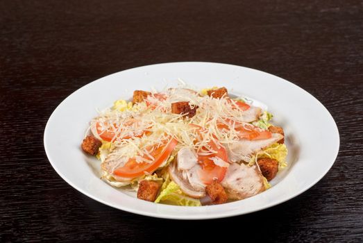 Salad of lettuce, chinese cabbage, tomato, garlic rusk, parmesan cheese, sauce and smoked salmon filet