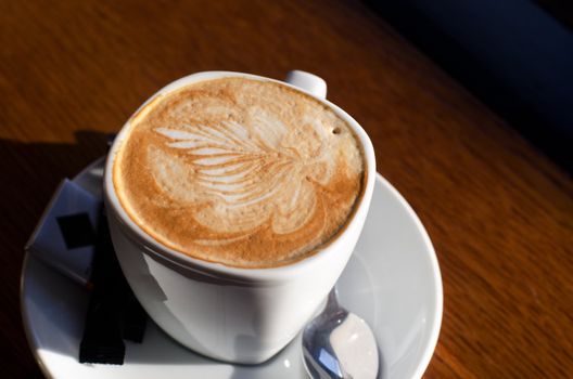 Cappuccino coffee cup closeup at the table