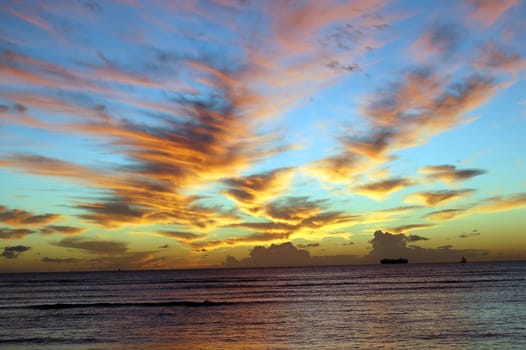 Clouds in different colors at Sunset on a Beach