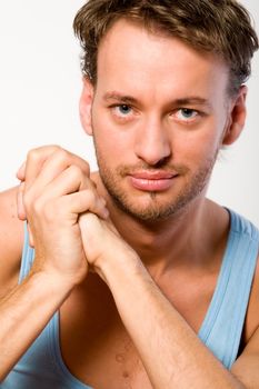 Studio portrait of a young adult man in a blue shirt