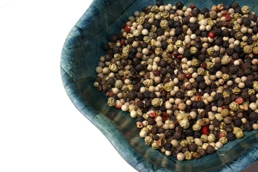 Bowl of pepper against white background.