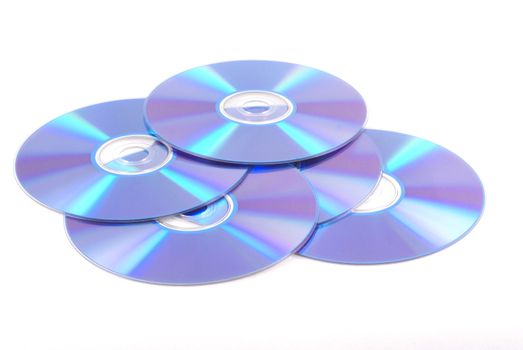 Five blank dvd's on a white background.           