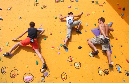 Annual Bouldering Competition on Scheveningen beach. Participants climbing artificial rock face.