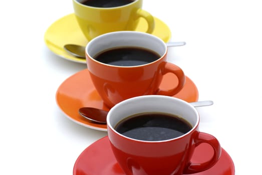 Three isolated cups of coffee.