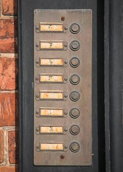 Row of numbered door bell buttons on a wall